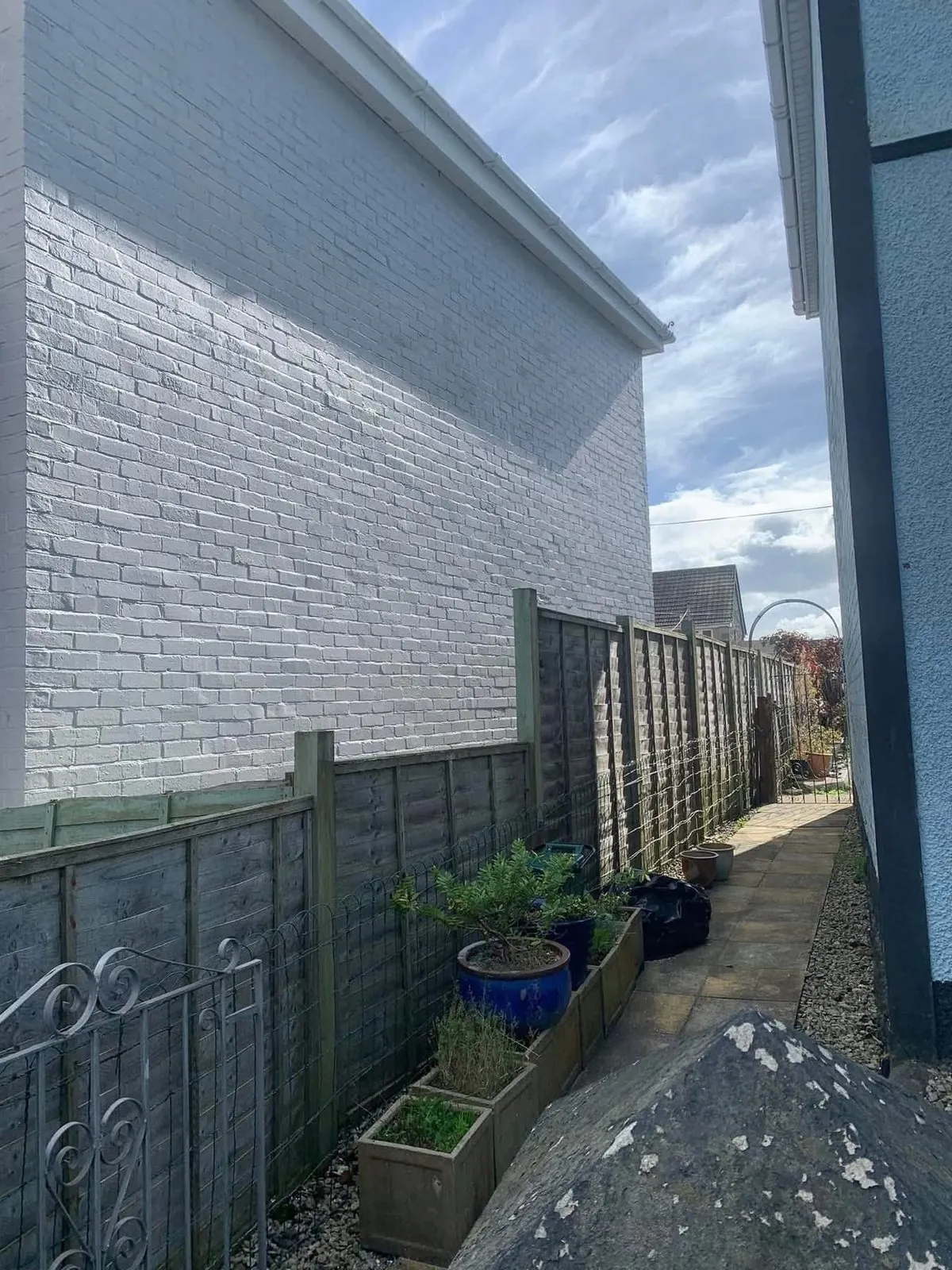 Freshly painted brick wall after preparation and masonry paint in Hayle