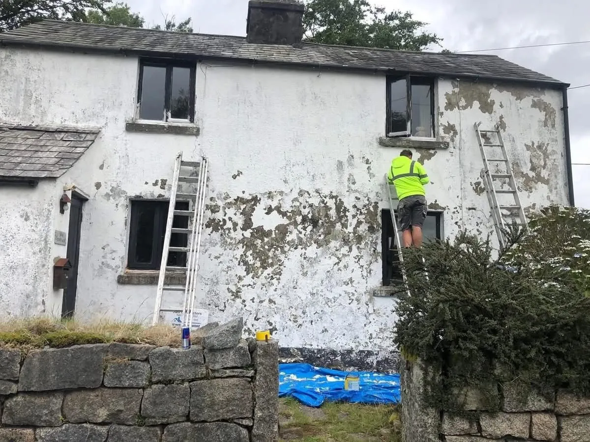 Cottage with blown, flaking render before repair in Hayle